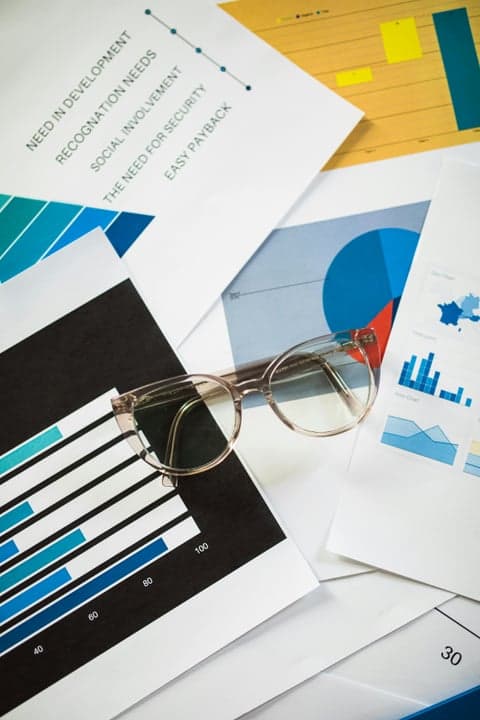 Research charts and graphs with glasses